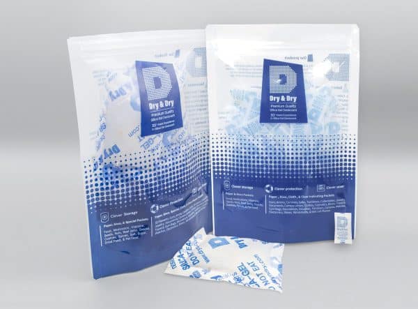 2 dessicant pouches standing on gray background