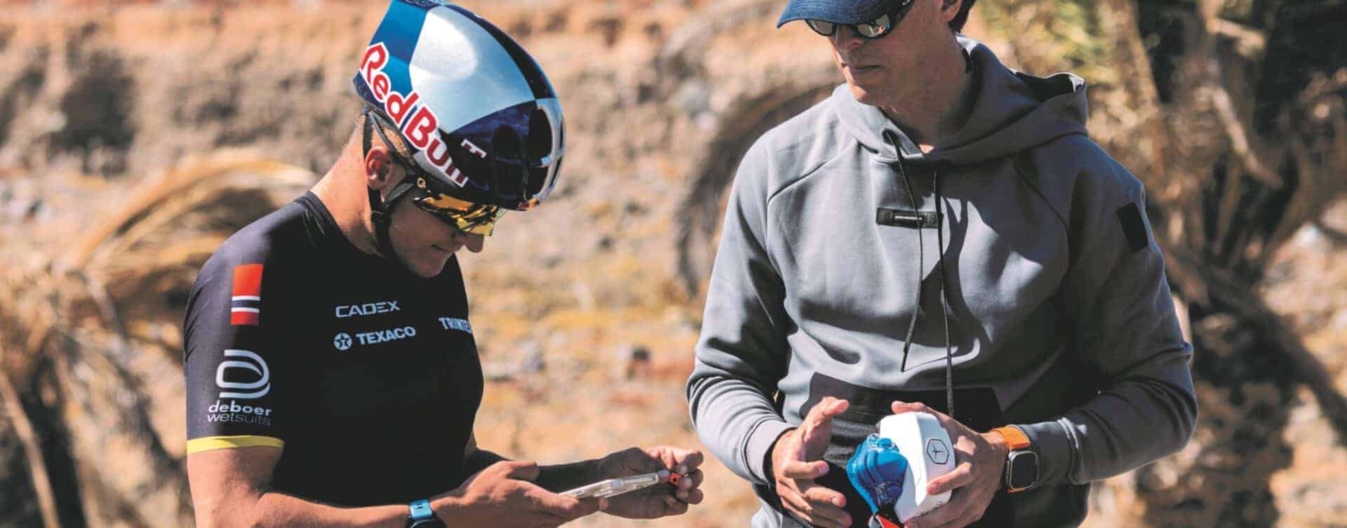 Biking athlete shown roadside with his coach using the VO2 master analyzer gaining new insights about vt1 vt2 and vo2 max
