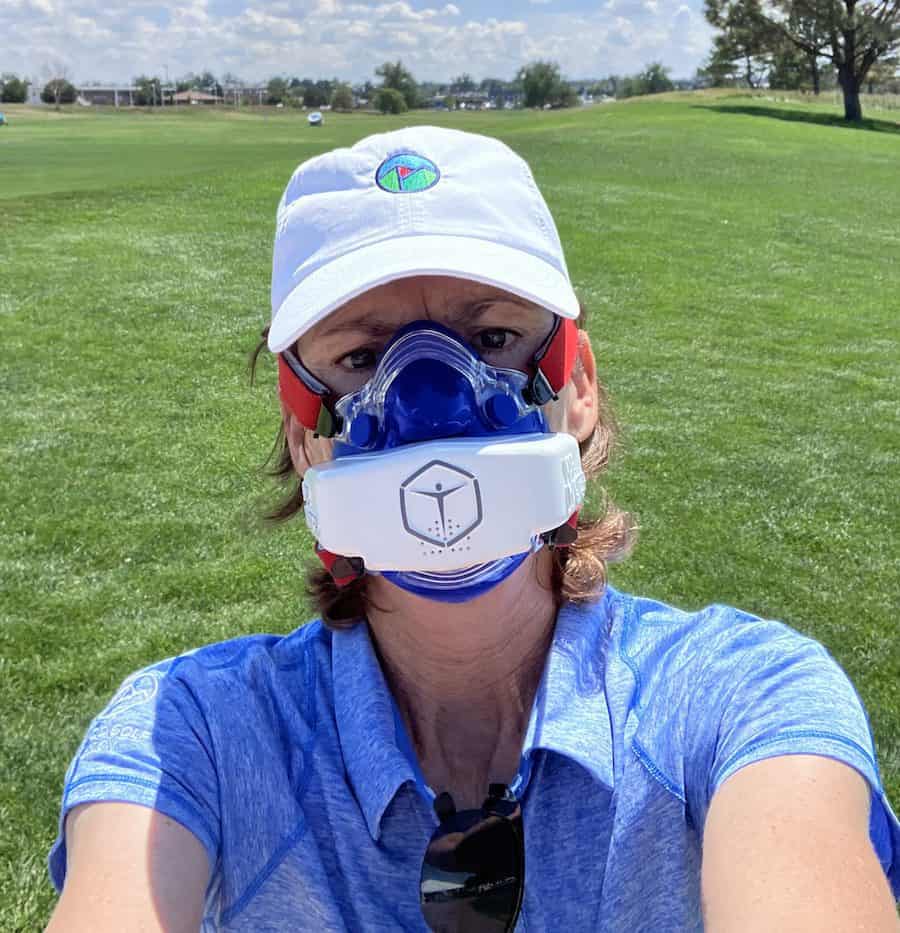 Woman taking a selfie wearing blue VO2 mask