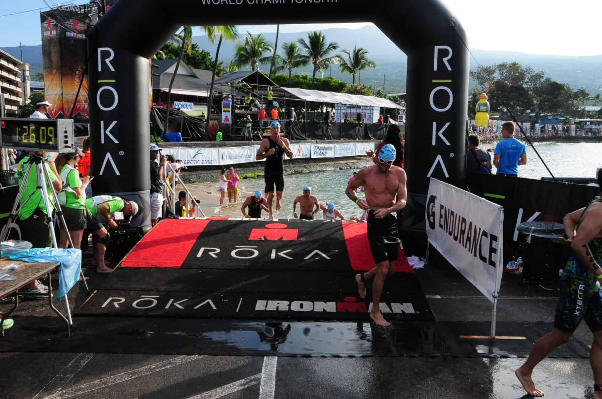 Ironman Triathlon swimmers exit the water